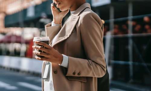 woman on phone with coffee