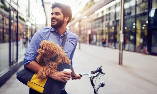 man carrying dog